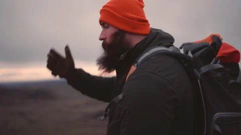 Man Standing on Cliff Overlooking Vast Icelandic Landscape Stock Footage 307421836