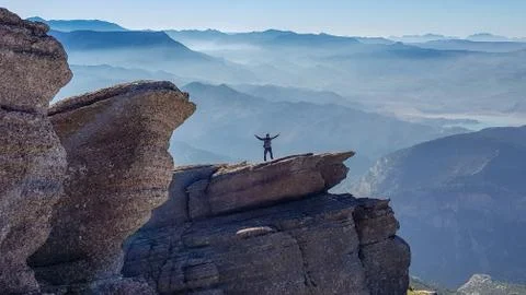 Man standing on cliff Stock Photos