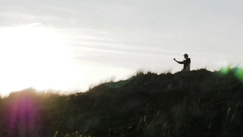 Man standing on coast and taking pictures on mobile phone Stock Footage 71564966