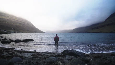 Man Standing At The Coastline Of Funningur Stock Footage 134286221
