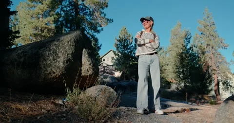 Man Standing Confidently in Rocky Forest Area Stock Footage 323348431