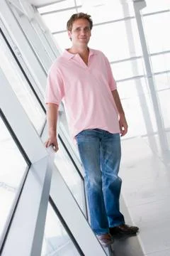 Man standing in corridor smiling Stock Photos