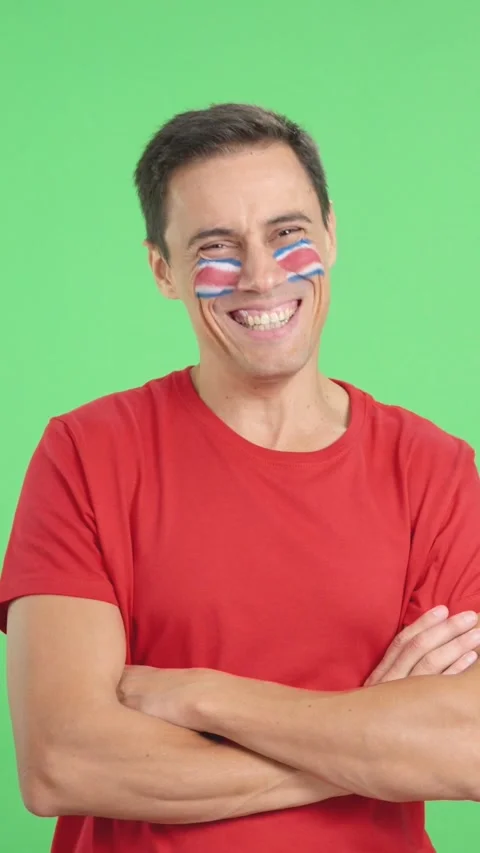 Man standing with costa rican flag painted on face smiling Stock Footage 260836629