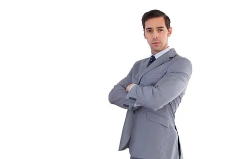 Man standing crossing arms in studio wearing gray suit white shirt dark tie, Stock Photos