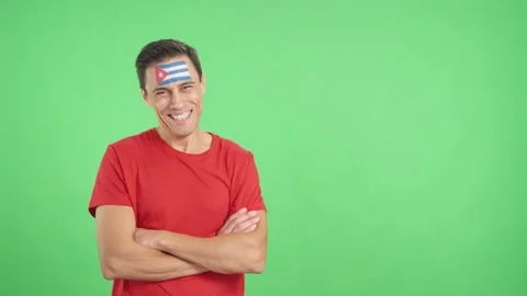 Man standing with cuban flag painted on face smiling Vídeo Stock 255533308