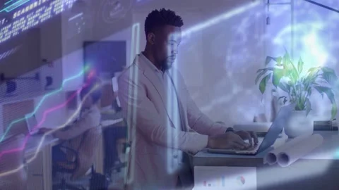 Man standing at desk typing on laptop, live tech feed sweeping overlays and Stock Footage 333594428
