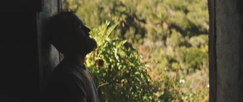 Man standing in the door frame looking out Stock Footage 202266997