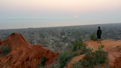 Man Standing Edge Cliff in Dramatic Landscape Stock Footage 149050431