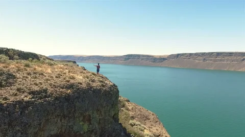 Man standing on a edge of the cliff. Stock Footage 65968099
