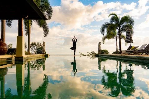 A man standing at the edge of infinity pool Stock Photos