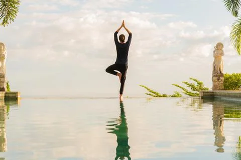 A man standing at the edge of infinity pool Stock Photos