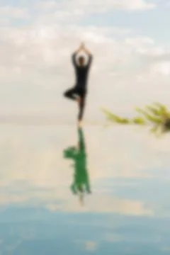 A man standing at the edge of infinity pool Stock Photos