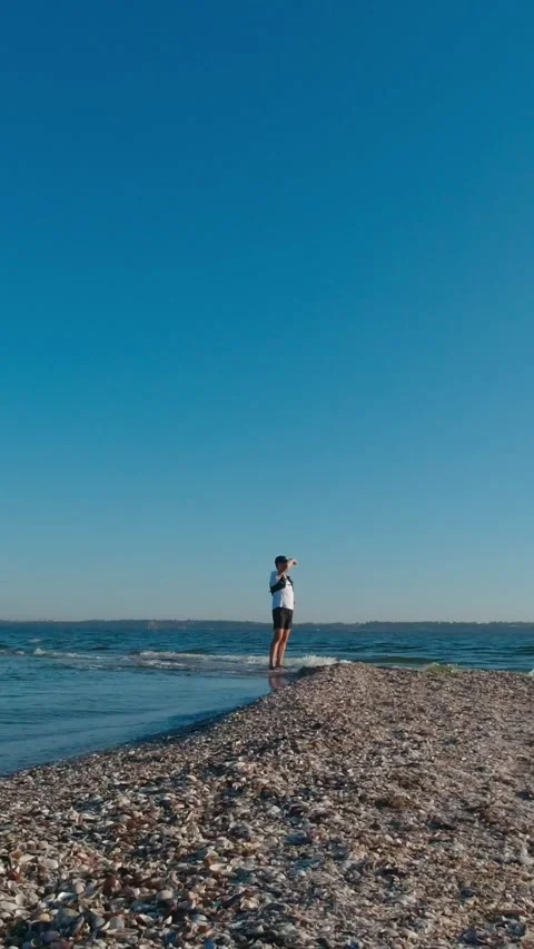A man is standing on the edge of Kinburn Split, Ukraine. Vertical Video Stock Footage 270214303