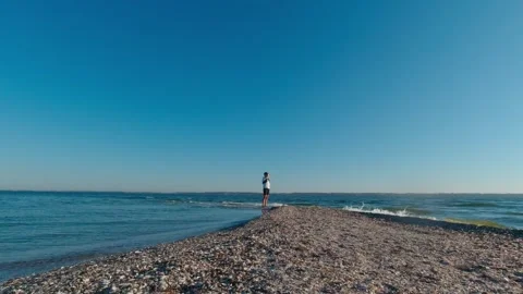 A man is standing on the edge of Kinburn Split, Ukraine Stock Footage 271261025