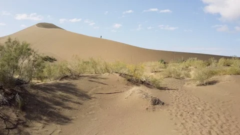Man Standing on the Edge of Sand Dune Stock Footage 107873552