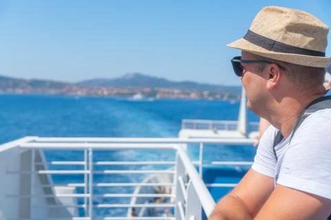 Man Standing on Ferry Deck, Sardinian, La Maddalena, Italy 写真素材