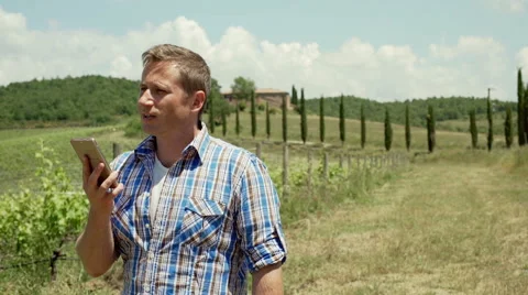 Man standing on the field and talking on loudspeaker, steadycam shot 스톡 동영상 66768293