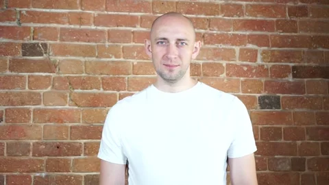 A man standing in front of a brick wall Stock Footage 134796105