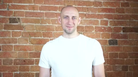 A man standing in front of a brick wall Stock Footage 134796194