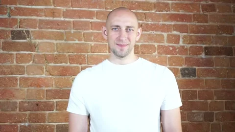 A man standing in front of a brick wall Stock Footage 134796312
