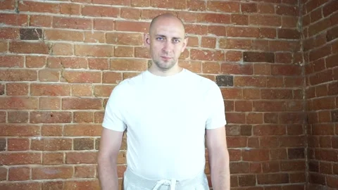 A man standing in front of a brick wall Stock Footage 134796448