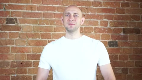 A man standing in front of a brick wall Stock Footage 135709317