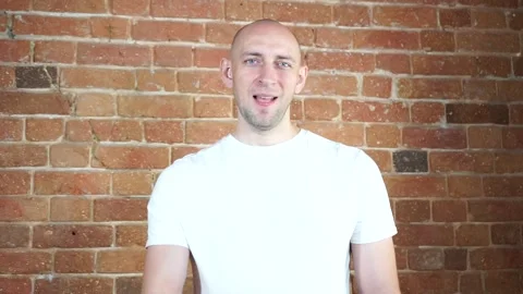 A man standing in front of a brick wall Video stock 135709357