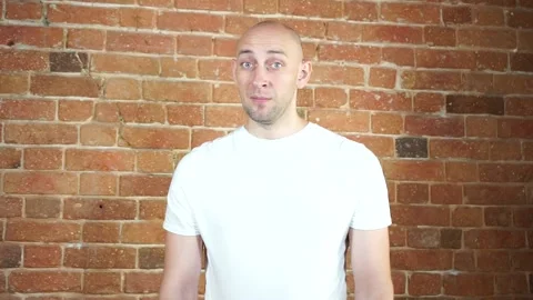 A man standing in front of a brick wall Stock Footage 135709462