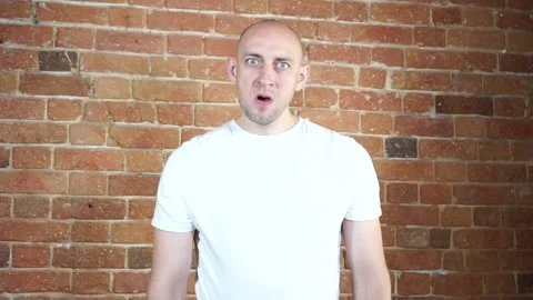 A man standing in front of a brick wall Stock Footage 135709568