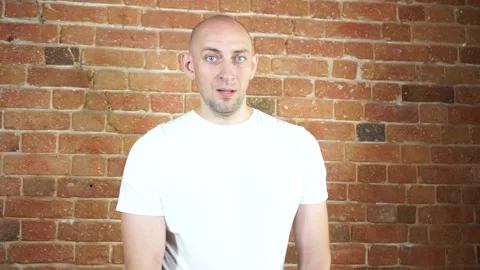 A man standing in front of a brick wall Stock Footage 135709621