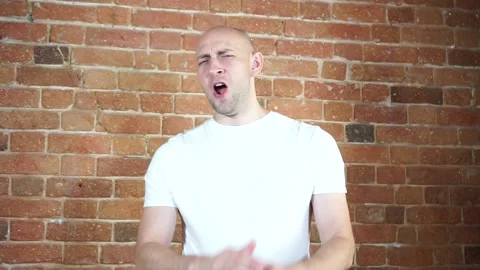 A man standing in front of a brick wall Stock Footage 135709635