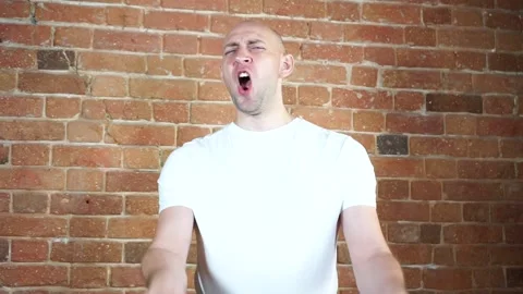 A man standing in front of a brick wall Stock Footage 135709668