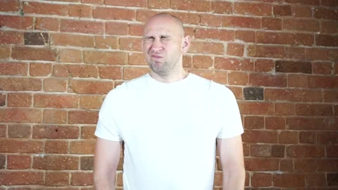 A man standing in front of a brick wall Stock Footage 135709695