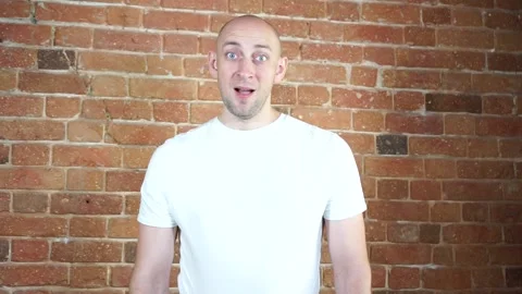 A man standing in front of a brick wall Stock Footage 135709810