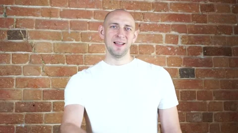 A man standing in front of a brick wall Stock Footage 135709838