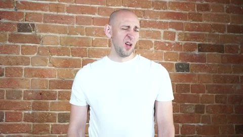 A man standing in front of a brick wall Stock Footage 135709893