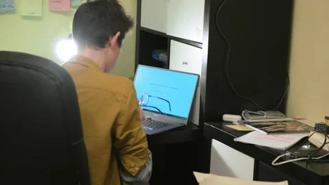 A man standing in front of a computer. Stock Footage 151785693