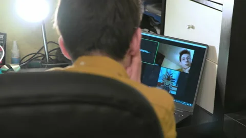 A man standing in front of a computer. Video conferencing. Stock Footage 151785837