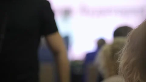 Man is standing in front of a crowd, holding a microphone Stock Footage 299973655