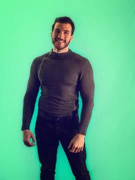 Man standing in front of green wall Stock Photos