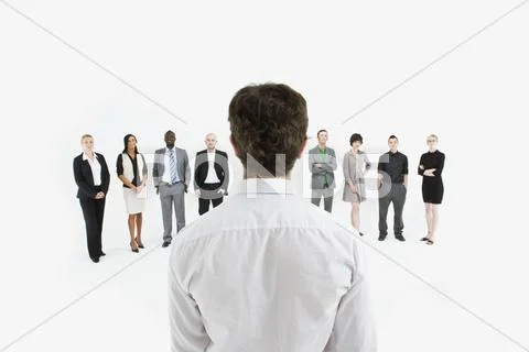 A man standing in front of a row of business people Stock Photos