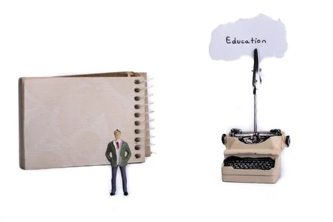 Man standing in front of a typewriter and a spiral notebook on a white Stock Photos