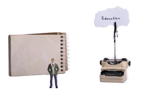 Man standing in front of a typewriter and a spiral notebook on a white Stock Photos