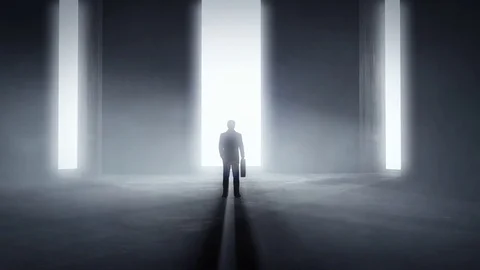 Man standing at the front of a wall with three opening entrances 库存影片 80315772