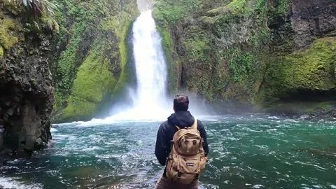 Man Standing in front of Waterfall Stock Footage 294120254