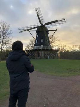 Man standing in front of Winding Mill in Europe Stock Photos