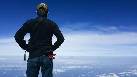 Man Standing with Hands on Hips on Clouds Stock Photos