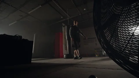 Man Standing with Hands on Hips in Dark Gym after Workout Stock Footage 340404149