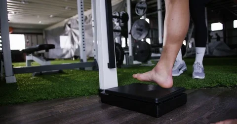 Man standing on height measuring equipment in gym 動画素材 77333431