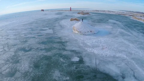 Man Standing On Iceberg Next to Pier Stock Footage 88675774